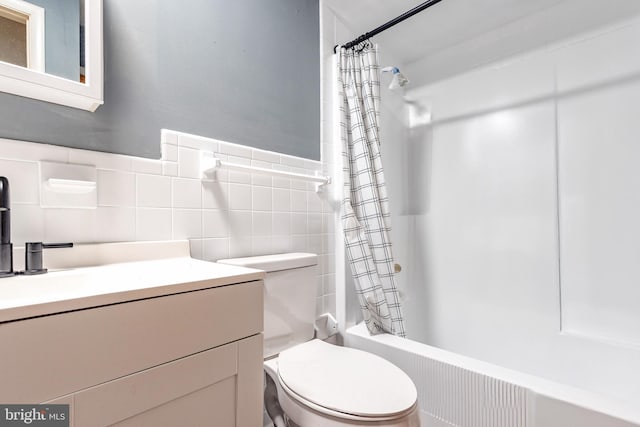 full bathroom featuring toilet, vanity, tile walls, and shower / bath combo with shower curtain