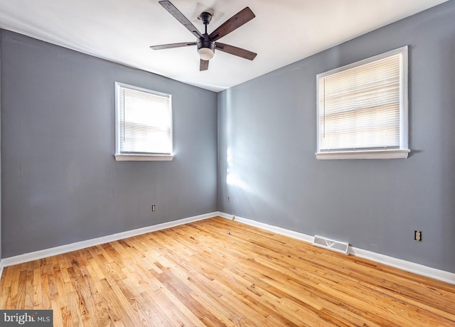 empty room featuring ceiling fan and light wood-type flooring