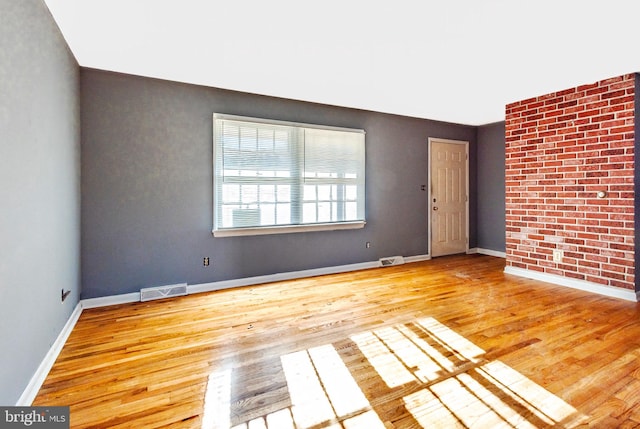 spare room with light hardwood / wood-style floors