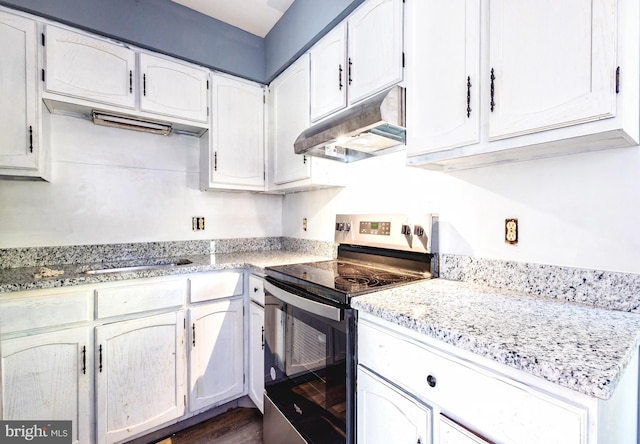 kitchen with dark wood-type flooring, stainless steel electric range, light stone countertops, and white cabinets