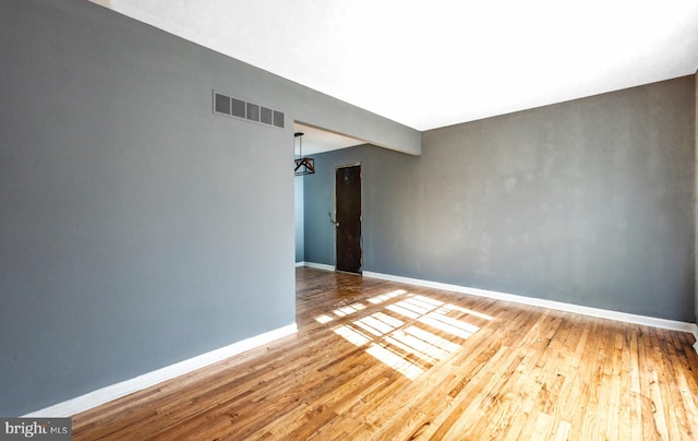 spare room featuring hardwood / wood-style floors