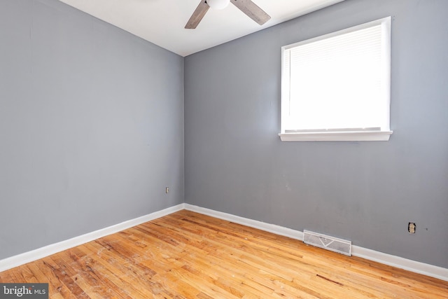 empty room with ceiling fan and light wood-type flooring