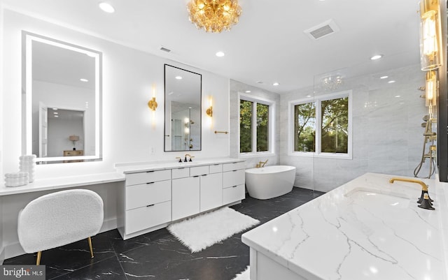 bathroom featuring a washtub, vanity, and tile walls