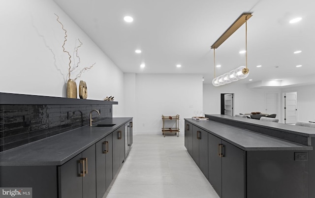 kitchen with pendant lighting, sink, and tasteful backsplash