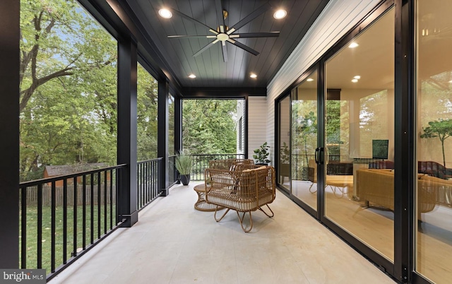 sunroom / solarium featuring ceiling fan