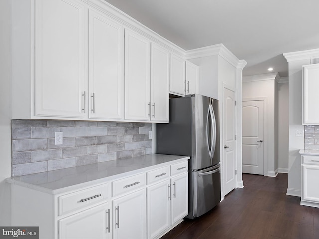 240 Baldy Ln, Middletown, DE 19709 - kitchen with dark wood-style flooring, white cabinets, backsplash, baseboards, and freestanding refrigerator