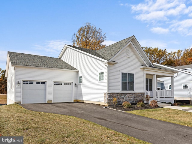 240 Baldy Ln, Middletown, DE 19709 - view of front of house with an attached garage, asphalt driveway, a front lawn, covered porch, and stone siding
