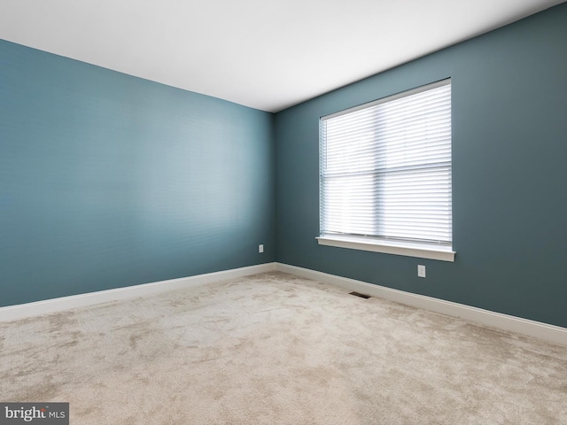 empty room with light colored carpet