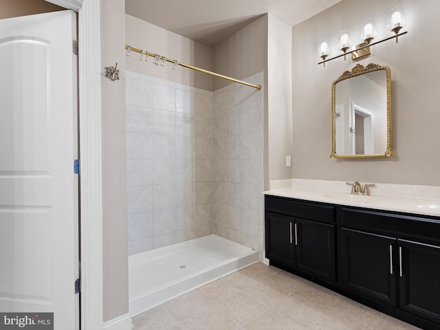 bathroom with vanity and tiled shower