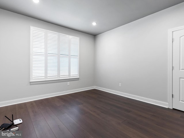 unfurnished room with dark hardwood / wood-style floors