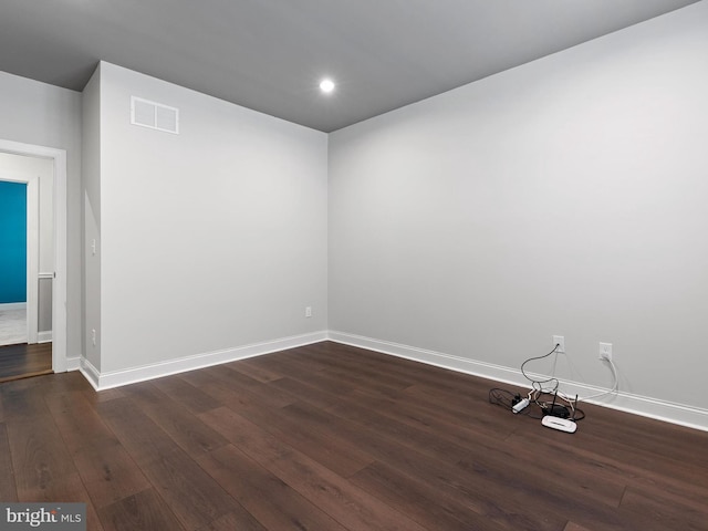 spare room with dark hardwood / wood-style flooring