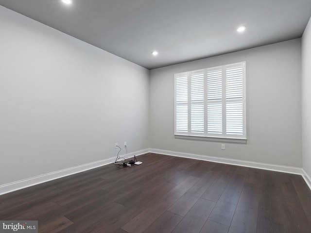 unfurnished room featuring dark wood-type flooring