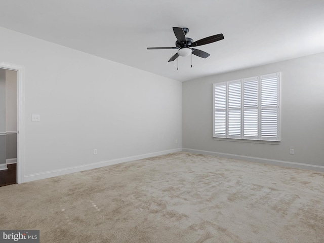 carpeted spare room with ceiling fan