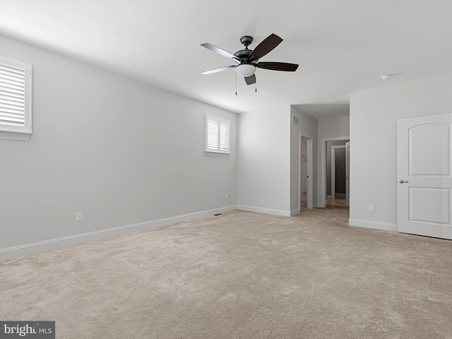 carpeted spare room with ceiling fan