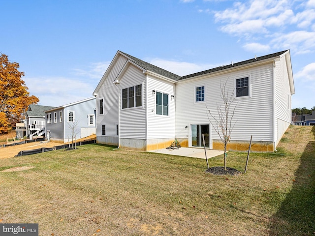 back of property featuring a lawn and a patio area