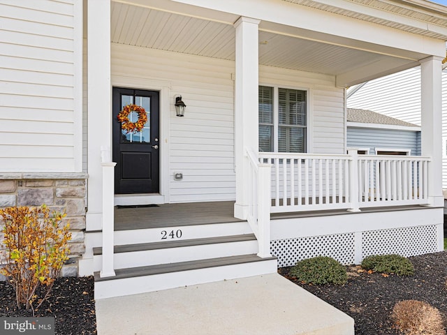 doorway to property featuring covered porch