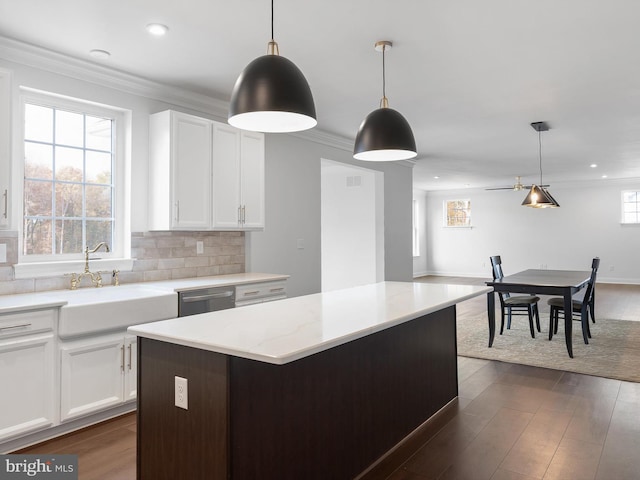 kitchen with white cabinetry, pendant lighting, and stainless steel dishwasher