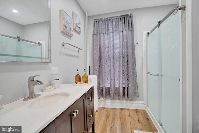 bathroom featuring vanity, hardwood / wood-style flooring, and a shower