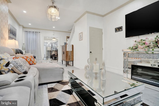 living room featuring a chandelier and crown molding