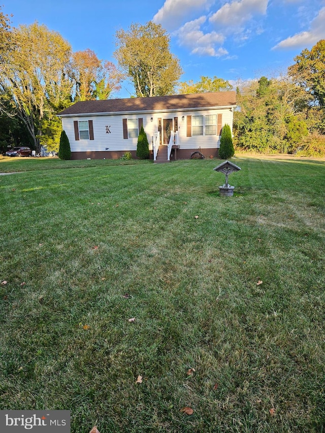 rear view of house with a yard