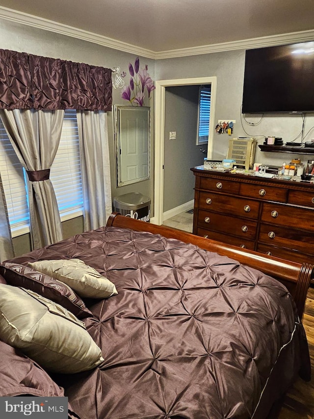 bedroom featuring hardwood / wood-style floors and crown molding