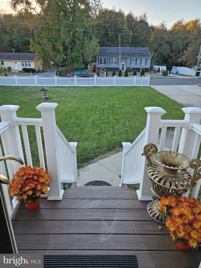 wooden terrace featuring a yard