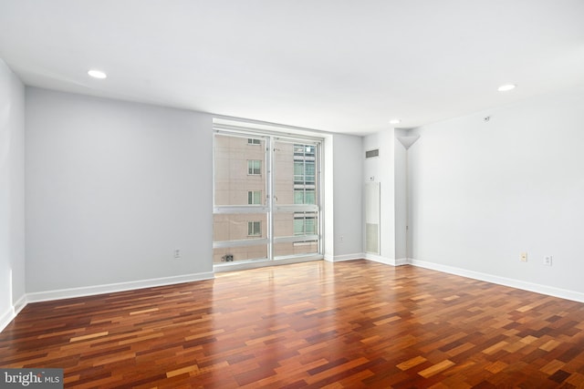 empty room with dark hardwood / wood-style flooring