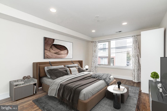 bedroom with dark wood-type flooring