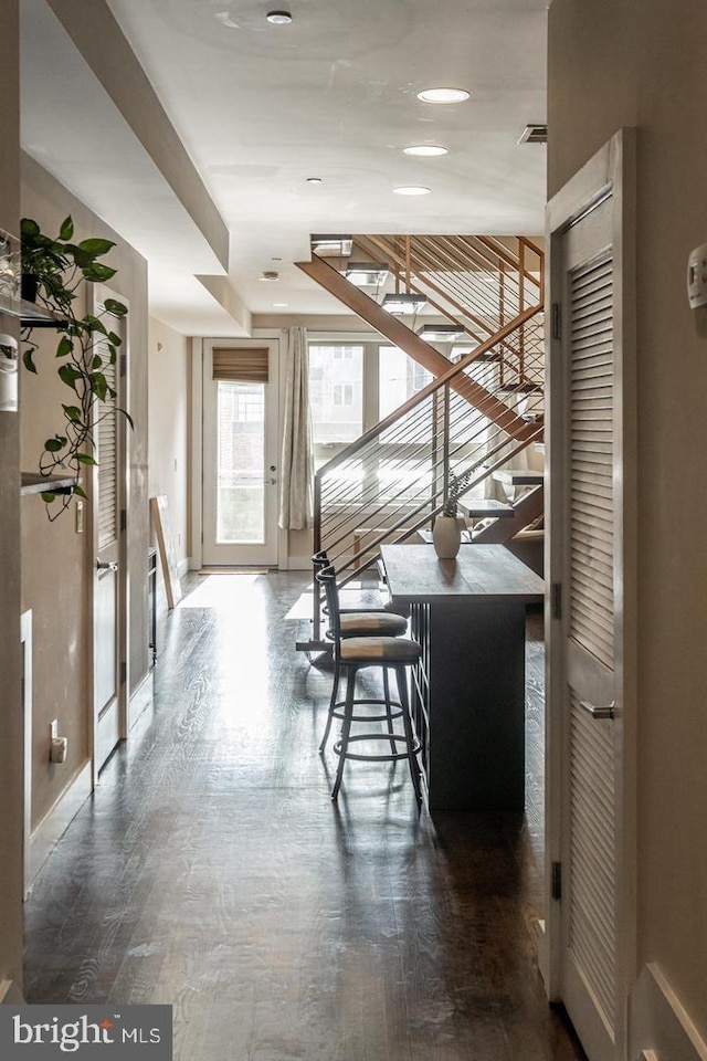 corridor featuring dark hardwood / wood-style flooring