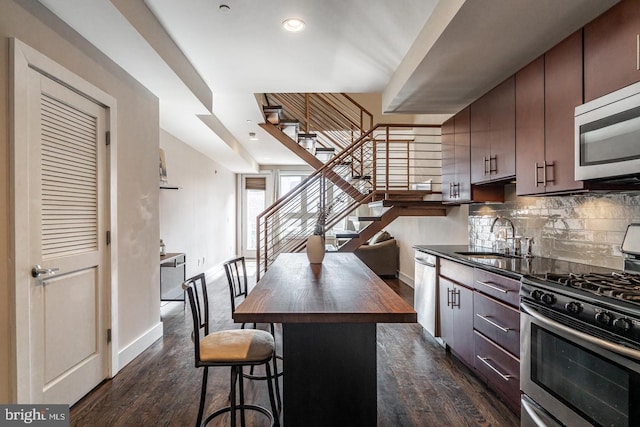 1538 Ogden St Unit 2A, Philadelphia, PA 19130 - kitchen with appliances with stainless steel finishes, baseboards, butcher block counters, and a sink