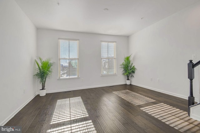 empty room with dark hardwood / wood-style floors