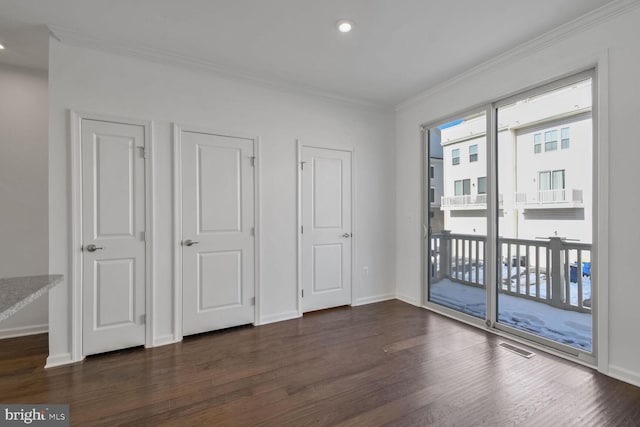 unfurnished bedroom featuring dark hardwood / wood-style flooring, crown molding, and access to outside