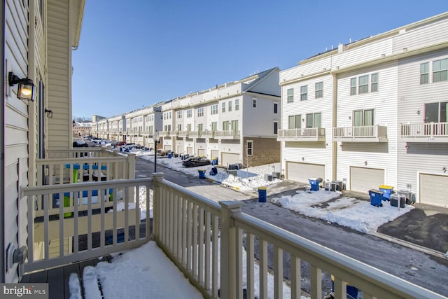 snow covered back of property featuring cooling unit