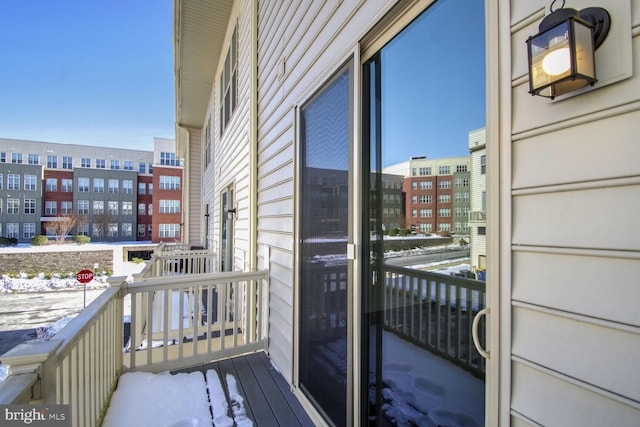 view of snow covered back of property