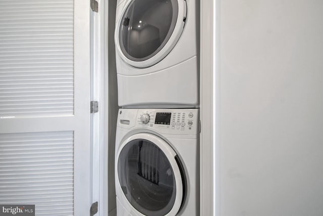 washroom with stacked washer / drying machine