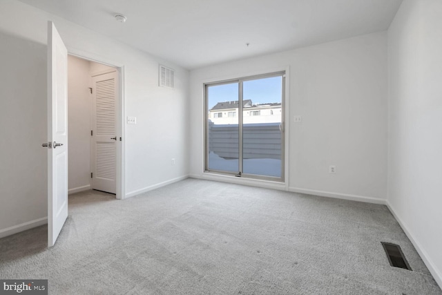 spare room with light colored carpet