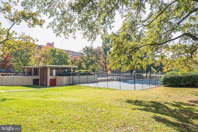 exterior space featuring a lawn and a swimming pool