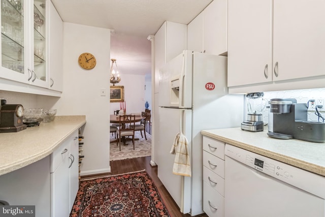 kitchen featuring dark wood-type flooring, white appliances, white cabinetry, and a textured ceiling