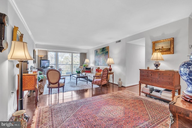 living room featuring wood-type flooring and crown molding