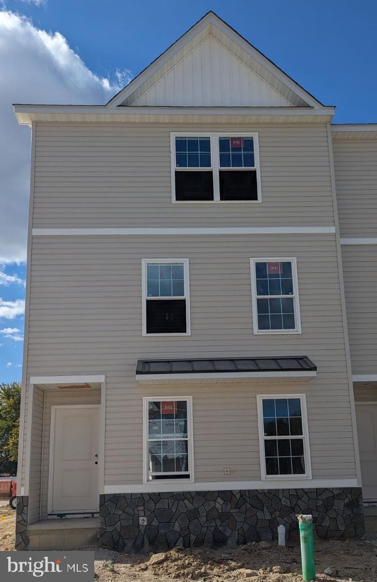 rear view of property featuring a garage