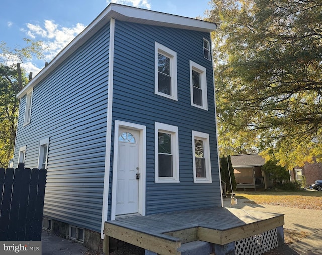 back of house with a deck