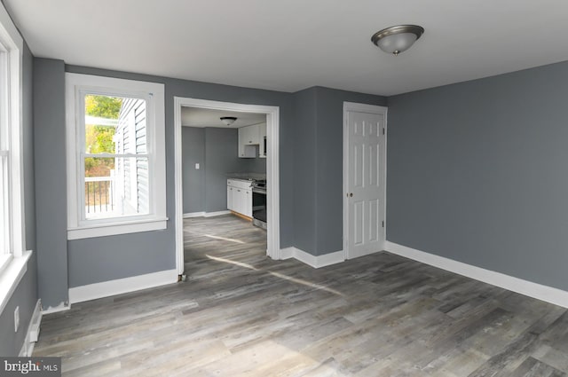 empty room with dark wood-type flooring