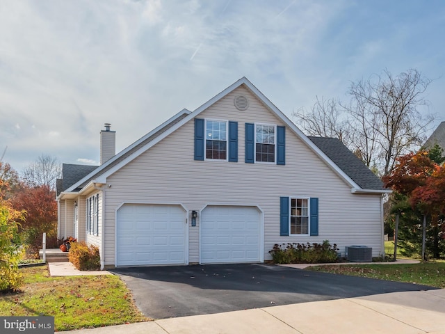 view of front of property with central air condition unit and a garage