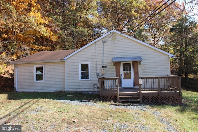 view of front facade with a front lawn and a deck