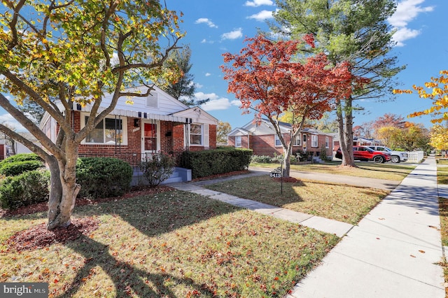 bungalow-style house with a front lawn