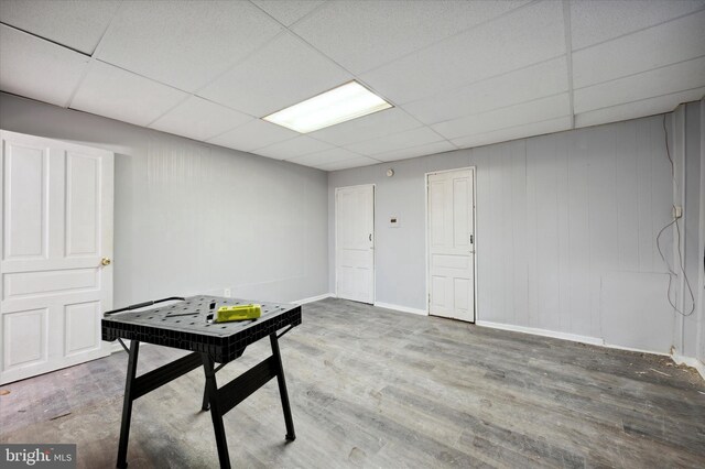 recreation room featuring wood-type flooring and a drop ceiling