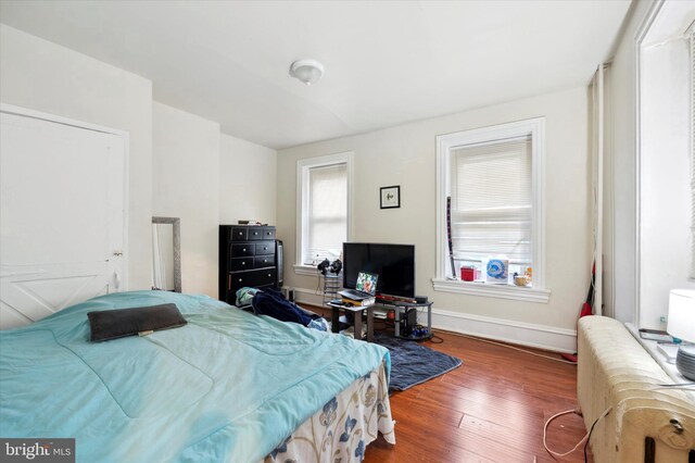 bedroom featuring dark hardwood / wood-style flooring