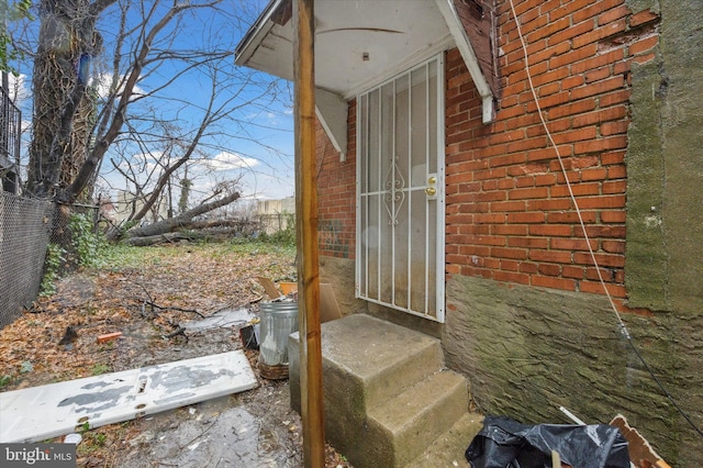 1612 N 54th St, Philadelphia, PA 19131 - doorway to property with brick siding and fence