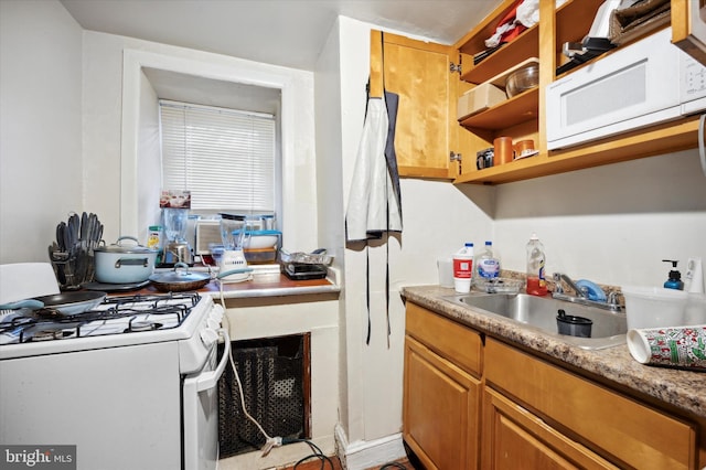 1612 N 54th St, Philadelphia, PA 19131 - kitchen featuring white appliances, a sink, open shelves, light countertops, and brown cabinets