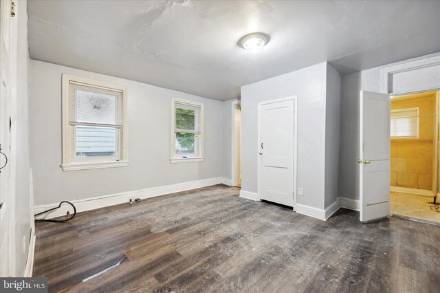 unfurnished bedroom featuring dark hardwood / wood-style flooring